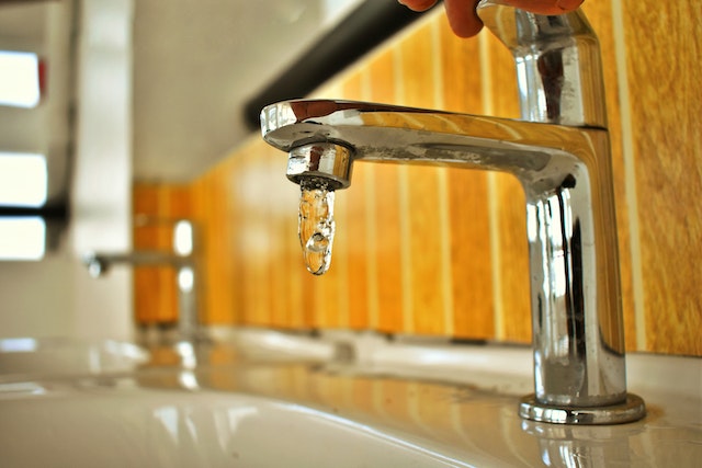 a faucet beginning to be turned on